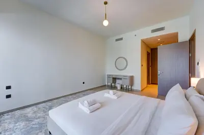 a white bedroom with a large bed and a couch at Stylish 2 Bed with Stunning Burj Khalifa View in Downtown in Dubai