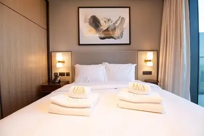 a hotel room with a bed with towels on it at Gorgeous High Floor 3-Bed with Full Burj View in Dubai