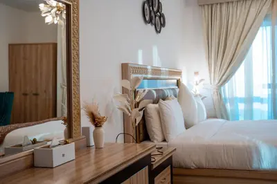 a bedroom with a large bed and a mirror at Veer Apartments - 87th Floor Penthouse Full Sea View 5 BHK in Dubai