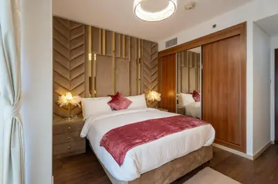 a bedroom with a large bed with red pillows at Veer Apartments - 87th Floor Penthouse Full Sea View 5 BHK in Dubai