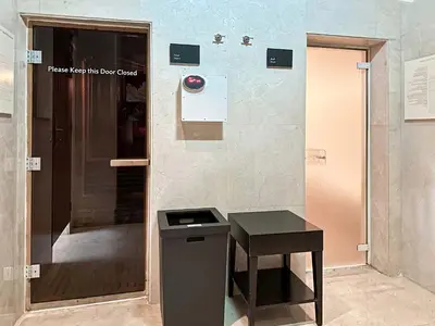 a bathroom with a trash can and a table at Splendid Cozy Studio - Address Dubai Marina in Dubai
