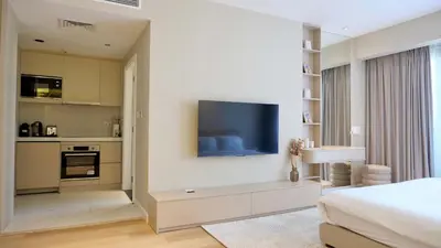 a bedroom with a tv on a wall with a bed at Splendid Cozy Studio - Address Dubai Marina in Dubai