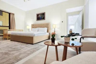 a bedroom with a bed and a coffee table at 4BR Jumeirah Beach Stay with Dubai Eye Views & Near Marina Walk in Dubai