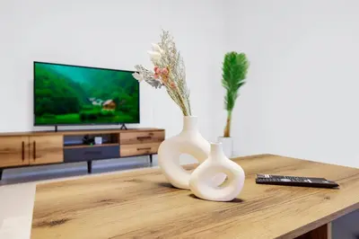 two white vases sitting on a table in a living room at 4BR Jumeirah Beach Stay with Dubai Eye Views & Near Marina Walk in Dubai
