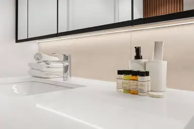 a kitchen counter with a sink with bottles ofodorizers at FIRST CLASS 2BR Serene Retreat in Wilton in Dubai