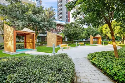 a park with benches and trees in a city at FIRST CLASS 2BR Serene Retreat in Wilton in Dubai