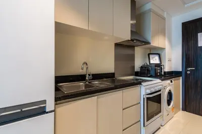 a kitchen with a sink and a dishwasher at GuestReady - Elegant retreat at Damac Hills in Dubai