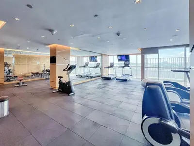 a gym with treadmills and ellipticals in a building at GuestReady - Elegant retreat at Damac Hills in Dubai