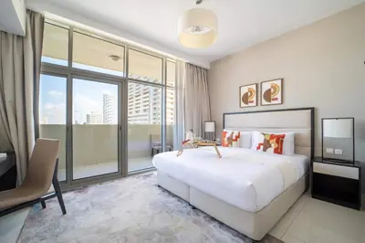 a bedroom with a large bed and a large window at Frank Porter - DAMAC Tower 108 - 1BR in Dubai