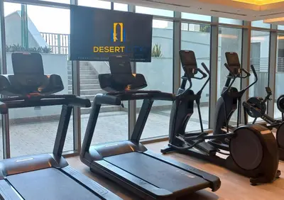 a gym with several cardio machines in a building at Fully Furnished 2 Bed in Sobha Creek Vista Reserve, Hosted by Desert City Stays in Dubai