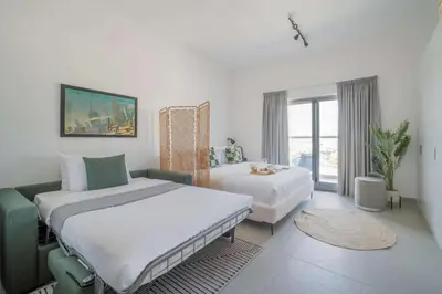 a hotel room with two beds and a window at Frank Porter - Bella Rose in Dubai