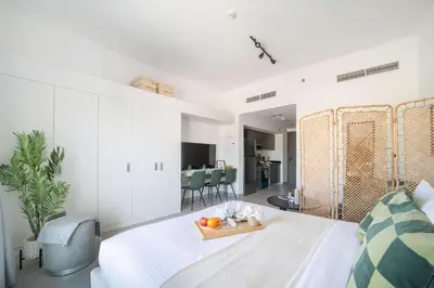 a bedroom with a bed with a tray of fruit on it at Frank Porter - Bella Rose in Dubai