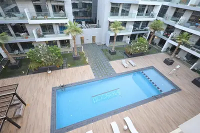 an overhead view of a large swimming pool in a building at VIP Experience Dubai Nad Al Sheba at Prime Views- Opposite Al Meydan Hotel- Modern Luxury Apartment in Dubai