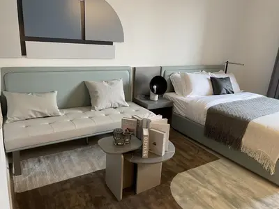 a living room with a bed and a couch at MAG 960 Stylish Luxury Apartment 6 Minutes to Burj Khalifa with Complimentary Guest Welcome Pack in Dubai