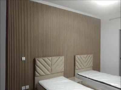 two beds in a room with brown striped walls at 3 bedroom Villa Downtown in Dubai