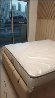 a bed in a room next to a window at 3 bedroom Villa Downtown in Dubai