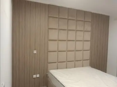 a bedroom with a bed and a wooden wall at 3 bedroom Villa Downtown in Dubai