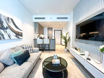 a living room with a couch and a table at Chic 1-Bedroom with Epic Burj Khalifa Views in Dubai