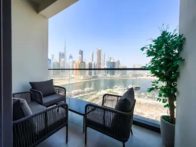 a balcony with chairs and a view of the city at Chic 1-Bedroom with Epic Burj Khalifa Views in Dubai