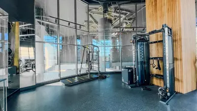 an empty room with a gym with a large window at Chic 1-Bedroom with Epic Burj Khalifa Views in Dubai