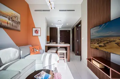 a living room with a couch and a tv at 1BR With Burj Khalifa View and Accomodates 4 People in Dubai