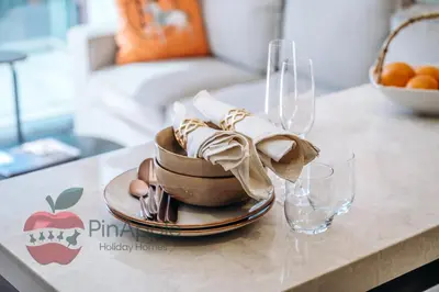 a table with a plate of food and glasses on it at 1BR With Burj Khalifa View and Accomodates 4 People in Dubai