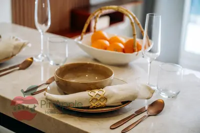 a table with a bowl of oranges and wine glasses at 1BR With Burj Khalifa View and Accomodates 4 People in Dubai