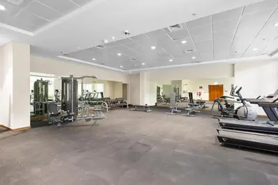 a gym with treadmills and machines in a room at Premium 1 bedroom Apartment near Dubai Mall in Dubai