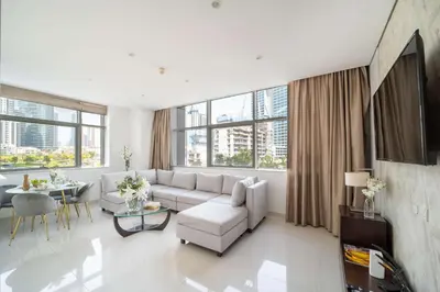a living room with a couch and a table at Frank Porter - Damac Cour Jardin in Dubai