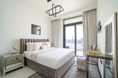 a bedroom with a large bed and a window at Frank Porter - Marina Vista Tower 2 in Dubai
