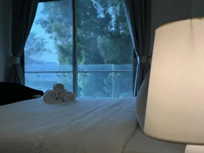 a bedroom with a bed with towels on it at Dubai Apartment in Meydan in Dubai