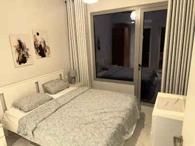 a bedroom with a bed and a large mirror at Nice 1BR in Dubai