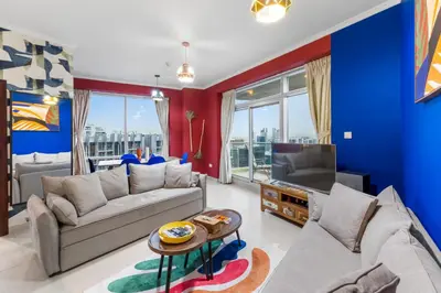 a living room with a couch and a tv at Burj Khalifa & Fountain View- 5mn walk to Dubai mall -Luxurious & Stylish 1BDR Apartment in Dubai