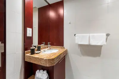 a bathroom with a sink and a mirror at Burj Khalifa & Fountain View- 5mn walk to Dubai mall -Luxurious & Stylish 1BDR Apartment in Dubai