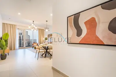 a living room with a large painting on a wall at Classy 1BR Apartment at Creek Horizon Tower 1, Dubai Creek Harbour by Deluxe Holiday Homes in Dubai