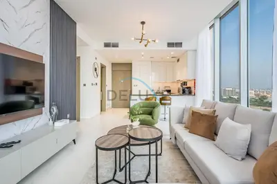 a living room with a couch and a table at Stunning 1BR Apartment in District One Phase III, Mohammed Bin Rashid by Deluxe Holiday Homes Al Maktoum City in Dubai