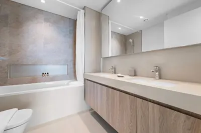 a bathroom with two sinks and a tub and a toilet at Silkhaus Full Burj Khalifa Views in Downtown in Dubai