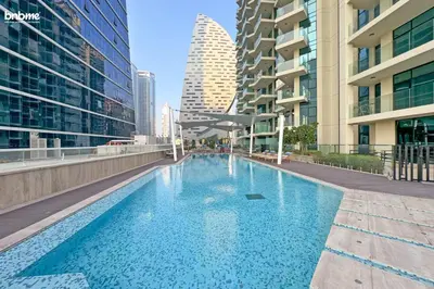 a swimming pool in a city with tall buildings at bnbmehomes - Urban Oasis by Missoni in Dubai
