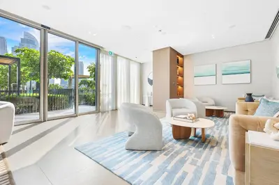 a living room with white furniture and large windows at FIRST CLASS 1BR Heart of Tranquility in Dubai