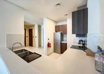 a kitchen with a sink and a refrigerator at Livbnb - 1B Palm Jumeirah and Sea View at Avani in Dubai