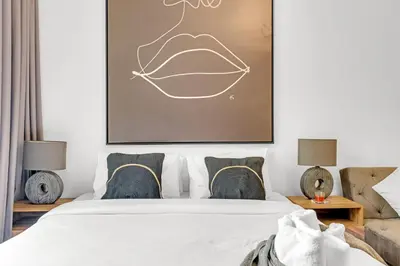 a bedroom with a bed with a picture above it at Comfy JVC Studio Pantheon Comfort & Style by Vibel in Dubai