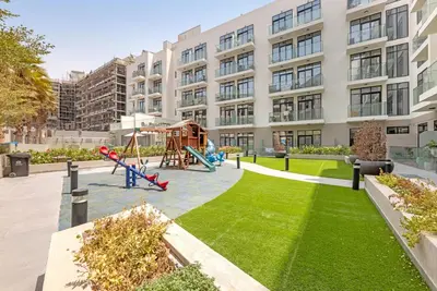 a playground in front of a building at Comfy JVC Studio Pantheon Comfort & Style by Vibel in Dubai