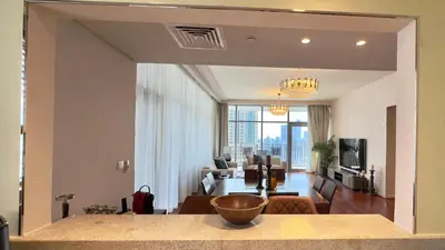 a living room with a table and a living room with a couch at Guest Favorite - Modern 3BR High Views Prime Location at Downtown in Dubai