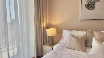 a bedroom with a bed with a lamp on a night stand at Guest Favorite - Modern 3BR High Views Prime Location at Downtown in Dubai