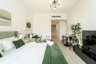 a living room with a large white bed and a green rug at Art of Modern Illumination in Dubai
