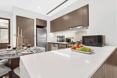 a kitchen with a counter with a bowl of fruit on it at FIRST CLASS 1BR Charming City View in Dubai