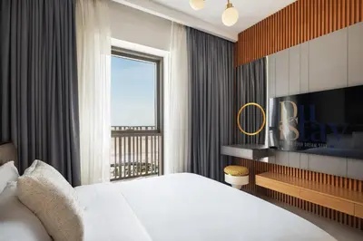 a bedroom with a large bed and a television at Waterfront Apartment at Dubai Creek Harbour - By DuStay in Dubai