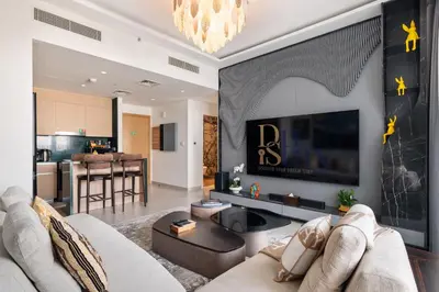 a living room with a couch and a tv at Waterfront Apartment at Dubai Creek Harbour - By DuStay in Dubai
