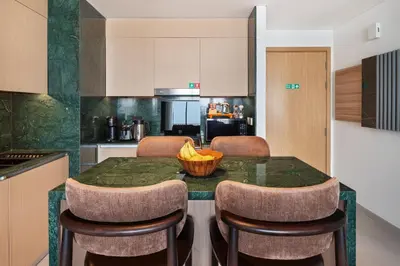 a kitchen with a table with a bowl of bananas on it at Waterfront Apartment at Dubai Creek Harbour - By DuStay in Dubai