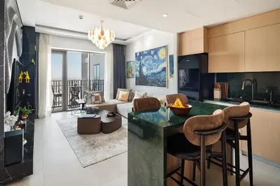 a kitchen and living room with a couch and a table at Waterfront Apartment at Dubai Creek Harbour - By DuStay in Dubai